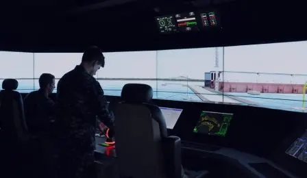Crew at the consoles of a ship bridge simulator
