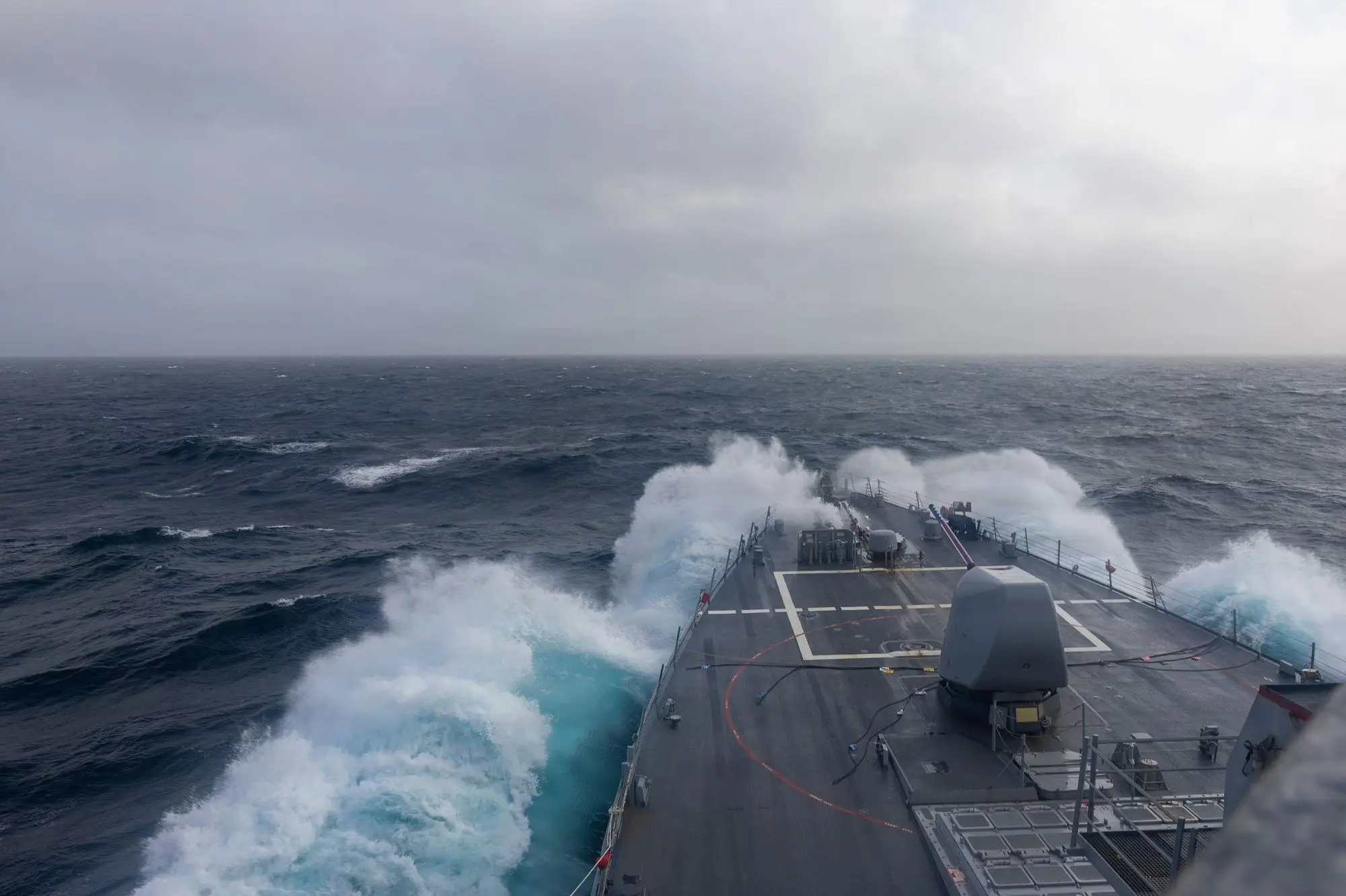 Destroyer bow cutting through heavy seas