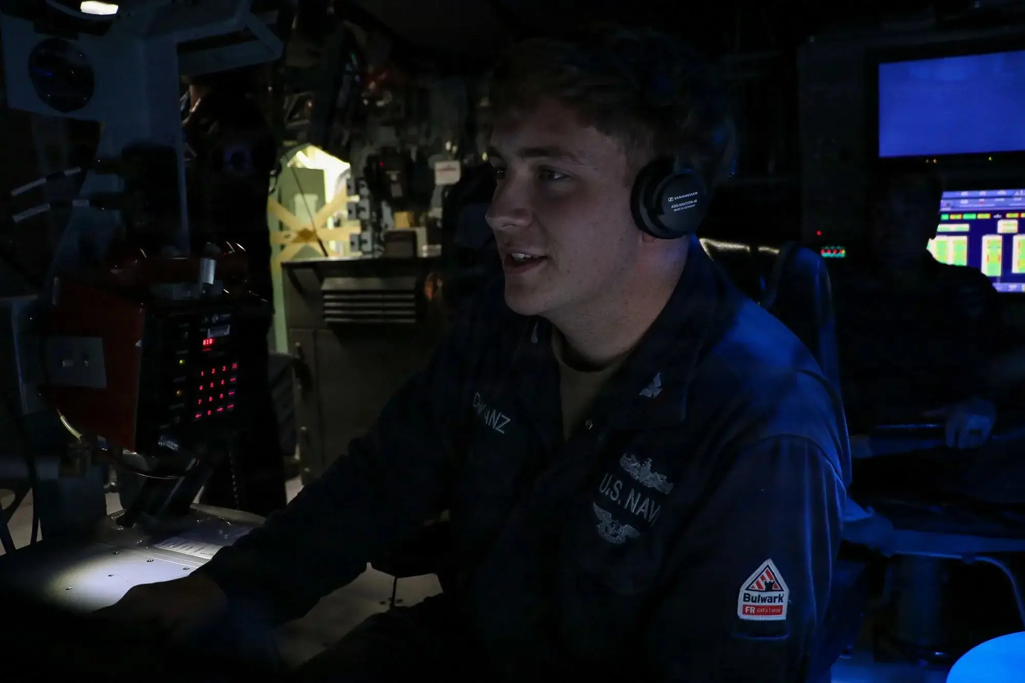 Sailor at a console during a combat systems training drill at sea